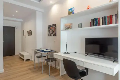 a living room with a tv and a table and chairs at Brand new apartment in Athens in Athens