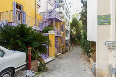 a narrow street with purple and yellow buildings at Brand new apartment in Athens in Athens