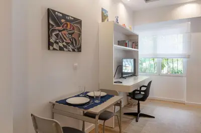 a room with a table and a desk with chairs at Brand new apartment in Athens in Athens