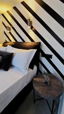 a bedroom with a bed and a table with a table at Essél Noir - A hidden gem with a magnificent Acropolis view in Athens