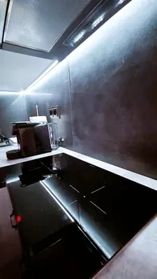 a kitchen with a stainless steel counter top at Essél Noir - A hidden gem with a magnificent Acropolis view in Athens