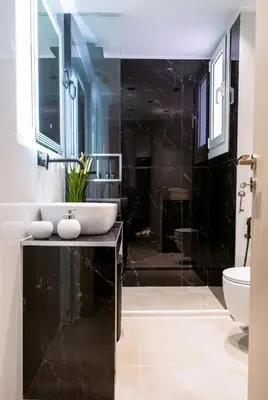 a black bathroom with a sink and a toilet at Essél Noir - A hidden gem with a magnificent Acropolis view in Athens