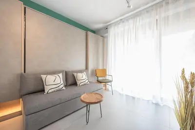 a living room with a couch and a table at Stylish Urban Suites in Athens