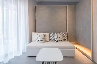 a living room with a couch and a table at Stylish Urban Suites in Athens