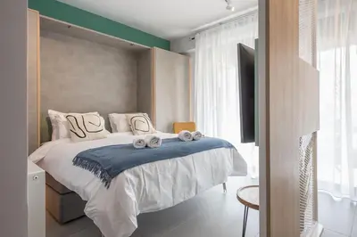 a bedroom with a bed with towels on it at Stylish Urban Suites in Athens