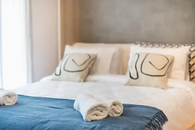 a bedroom with two beds with towels on them at Stylish Urban Suites in Athens