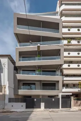 an apartment building with balconies on a street at Stylish Urban Suites in Athens
