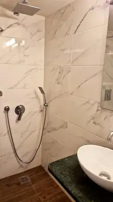 a white bathroom with a sink and a shower at Chic apt near Acropolis - Avdi square in Athens