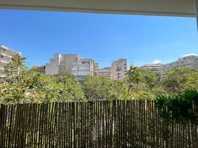 a fence in front of a city with tall buildings at Chic apt near Acropolis - Avdi square in Athens
