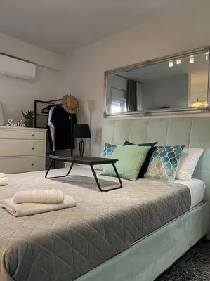 a bedroom with a bed with a table on it at Chic apt near Acropolis - Avdi square in Athens