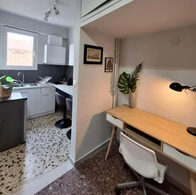 a small kitchen with a desk and a table at Stylish and central apt near Acropolis - Avdi square in Athens