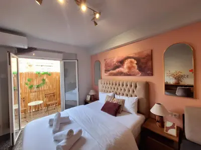 a bedroom with a large bed with two towels on it at Stylish and central apt near Acropolis - Avdi square in Athens