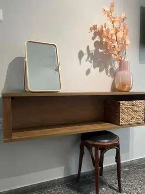 a wooden shelf with a mirror and a stool at Stylish and central apt near Acropolis - Avdi square in Athens