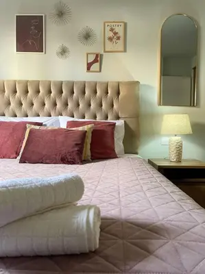 a bedroom with a large bed with a large headboard at Stylish and central apt near Acropolis - Avdi square in Athens