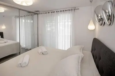 a white room with a table with shoes on it at Sea view penthouse in Vari in Vari