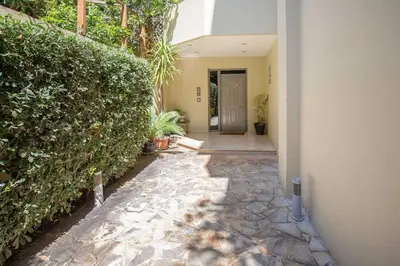 a hallway of a house with a hedge at Sea view penthouse in Vari in Vari