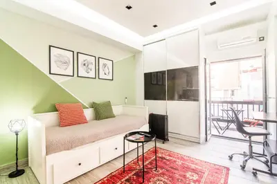 a bedroom with a bed and a table and chairs at Luxury Studio in Athens City Center in Athens