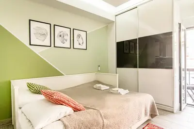 a bed in a room with green walls at Luxury Studio in Athens City Center in Athens