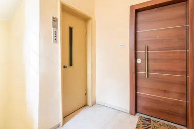 a wooden door in a room with a hallway at Luxury Studio in Athens City Center in Athens