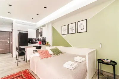 a small bedroom with a bed and a kitchen at Luxury Studio in Athens City Center in Athens