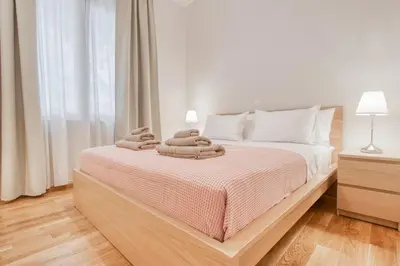 a bedroom with a bed with towels on it at Modern 2-bedroom apt, 200m from the Acropolis in Athens