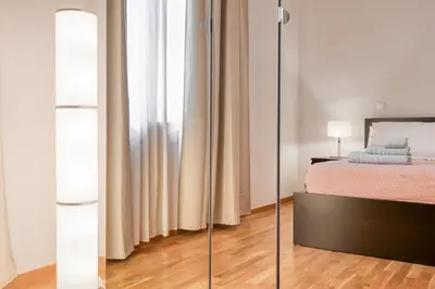a bedroom with a bed and a mirror at Modern 2-bedroom apt, 200m from the Acropolis in Athens