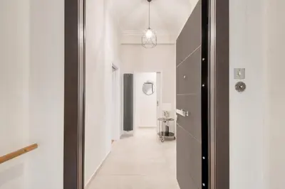 a hallway with a door leading into a room at Modern 2-bedroom apt, 200m from the Acropolis in Athens