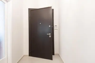 a black elevator door in a white room at Modern 2-bedroom apt, 200m from the Acropolis in Athens