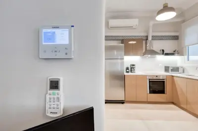 a kitchen with an electronic device on the wall at Modern 2-bedroom apt, 200m from the Acropolis in Athens