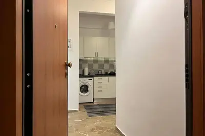 an open door to a kitchen with a washing machine at Pame Rentals - Ideal for 2 in Pagrati in Athens