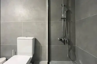 a bathroom with a shower with a toilet in it at Pame Rentals - Ideal for 2 in Pagrati in Athens
