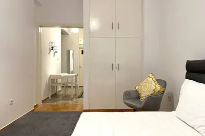 a bedroom with a bed and a chair and a table at Pame Rentals - Ideal for 2 in Pagrati in Athens
