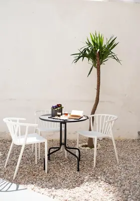 a table and two chairs and a palm tree at Patio Apartment near metro & Acropolis in Athens