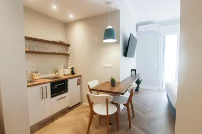 a kitchen and dining room with a table and chairs at Patio Apartment near metro & Acropolis in Athens