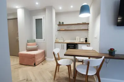 a kitchen and dining room with a table and chairs at Patio Apartment near metro & Acropolis in Athens