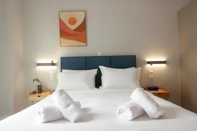 a bedroom with a white bed with two white pillows at Patio Apartment near metro & Acropolis in Athens