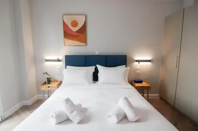 a bedroom with a large white bed with two pillows at Patio Apartment near metro & Acropolis in Athens