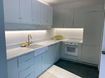 a white kitchen with white cabinets and a sink at ATHENS CENTRAL APARTMENT in Athens
