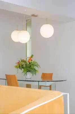 a dining room with a table and two lights at ATHENS CENTRAL APARTMENT in Athens