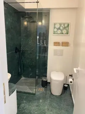 a bathroom with a glass shower and a toilet at ATHENS CENTRAL APARTMENT in Athens