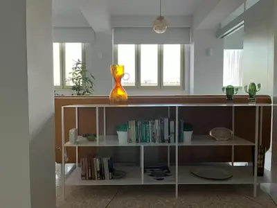 a book shelf with a vase sitting on top of it at ATHENS CENTRAL APARTMENT in Athens