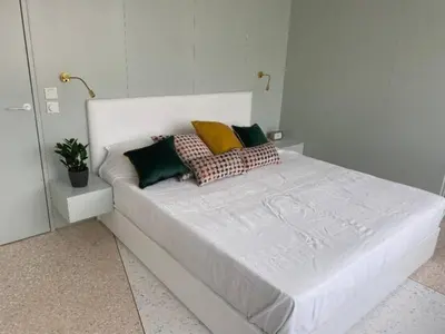 a white bed with pillows on it in a bedroom at ATHENS CENTRAL APARTMENT in Athens