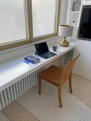 a desk with a laptop and a lamp and a chair at ATHENS CENTRAL APARTMENT in Athens