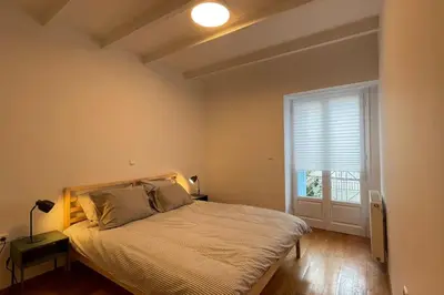 a bedroom with a large bed and a window at Cute apartment at the foot of lycabettus hill in Athens