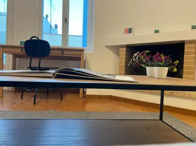 a table in a room with a desk and a fireplace at Cute apartment at the foot of lycabettus hill in Athens