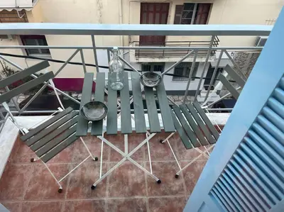 an overhead view of a table and chairs on a balcony at Cute apartment at the foot of lycabettus hill in Athens