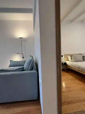 a living room with a couch and a bed at Cute apartment at the foot of lycabettus hill in Athens