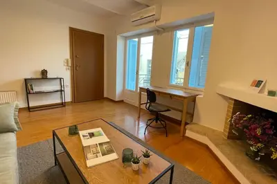 a living room with a table and a desk at Cute apartment at the foot of lycabettus hill in Athens