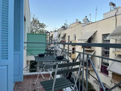 a balcony with a table with bowls on it at Cute apartment at the foot of lycabettus hill in Athens