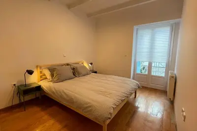 a bedroom with a large bed and a window at Cute apartment at the foot of lycabettus hill in Athens